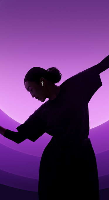 Silhouette of a woman dancing while wearing AirPods Pro.