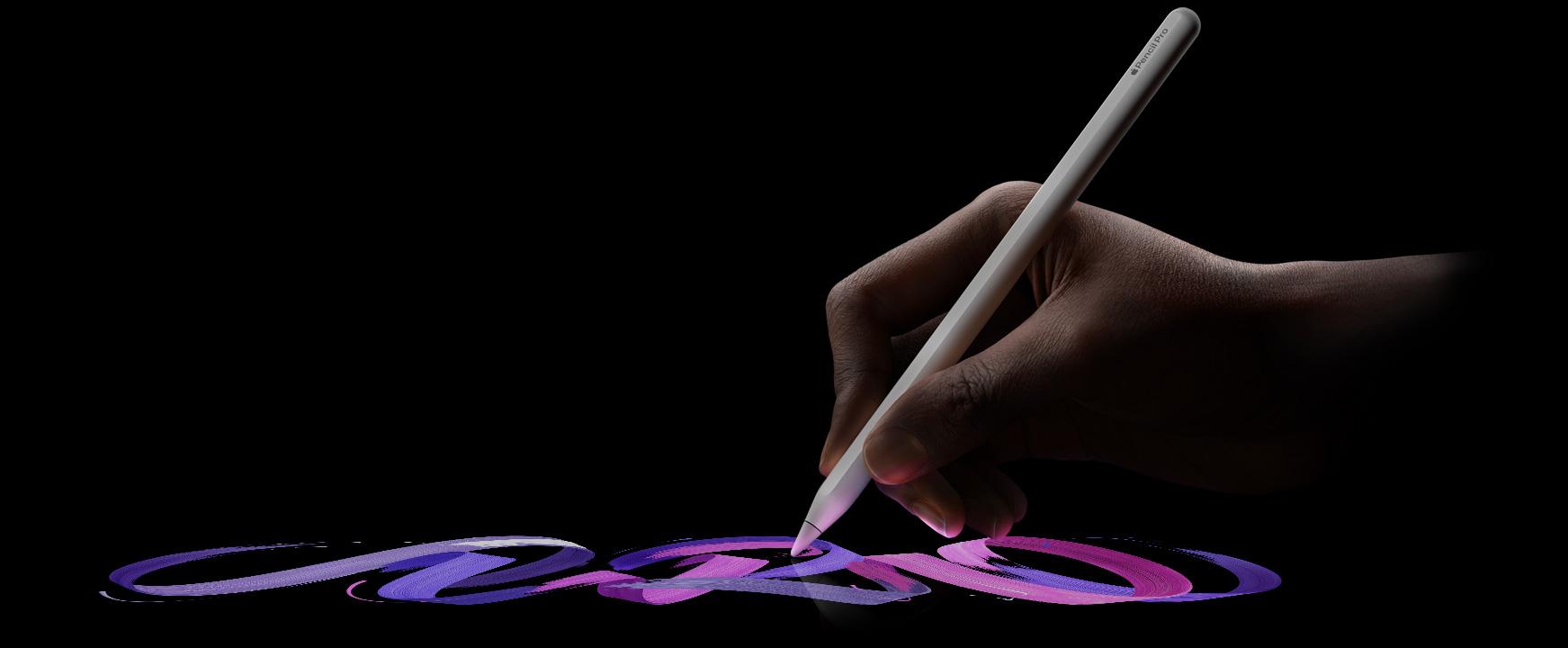 Uma mão segura o Apple Pencil Pro enquanto traça uma linha vibrante em estilo pincel.