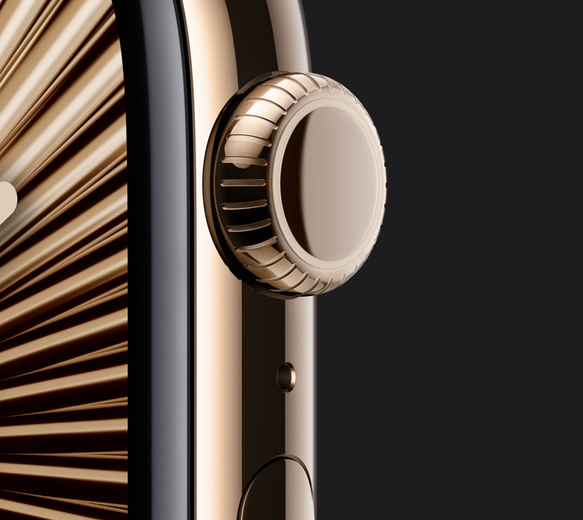 The Natural titanium finish, Gold titanium finish, and Slate titanium finish of three Apple Watch Series 10 cases with a closeup of the side of their Digital Crowns. An interactive finish selector is below them.