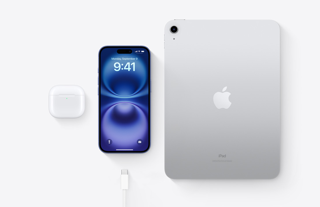 A birds-eye view of AirPods Pro, iPhone 16, and an iPad with a USB-C connector to demonstrate how all three devices can be charged using the same USB-C cable.