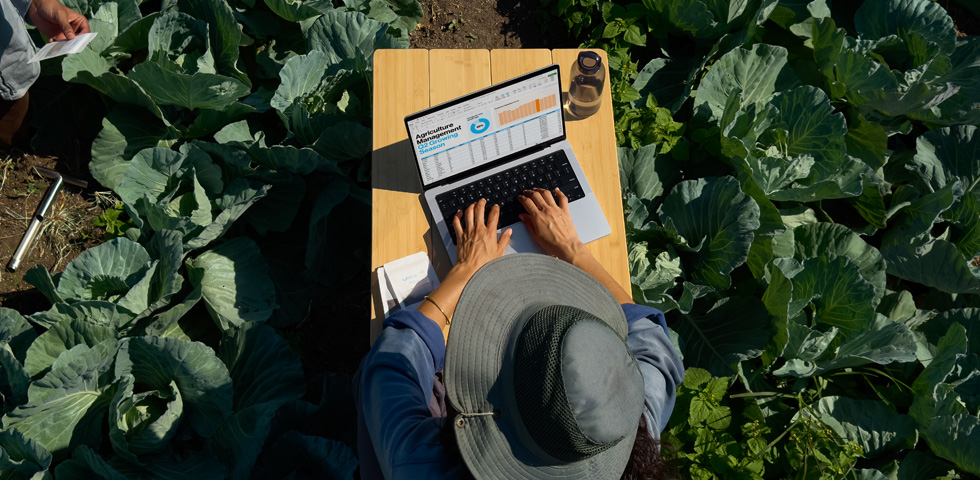 A person uses MacBook Pro with nano-texture display option outside, demonstrating the reduction in glare